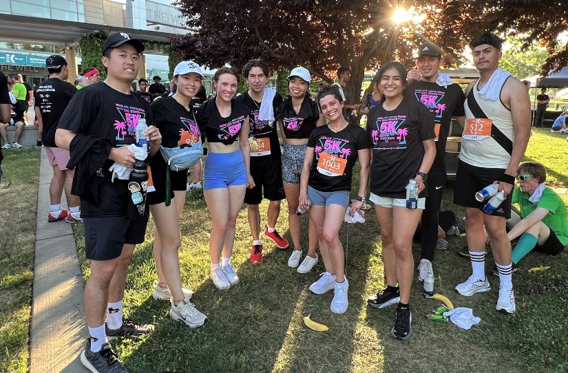 Nancy Gomez and her friends take a rest near the finish line after completing the 5K.