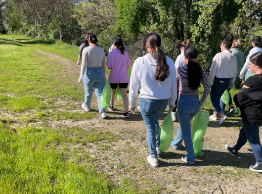 A group of students walks near the American River bike trail. They later broke off into groups of two or three to better search for trash. 